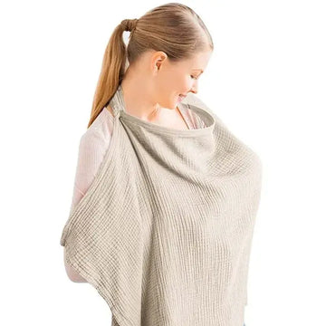 A woman wearing a stylish khaki nursing cover, providing privacy and comfort during breastfeeding.