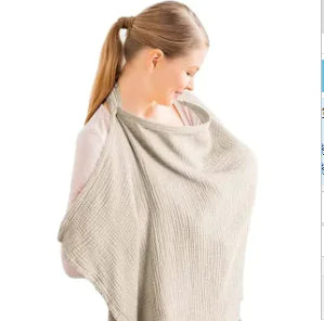 Breastfeeding in style with a chic khaki cotton maternity cape blanket for privacy and comfort.